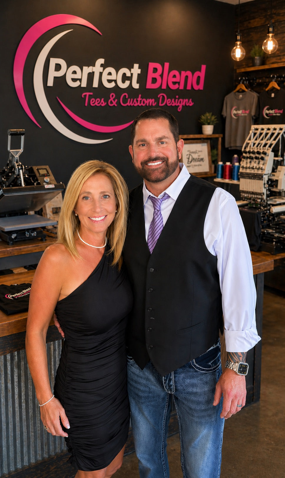 Ryan and Kelly Brown, the founders of Perfect Blend Tees & Custom Designs, standing together in their shop.
